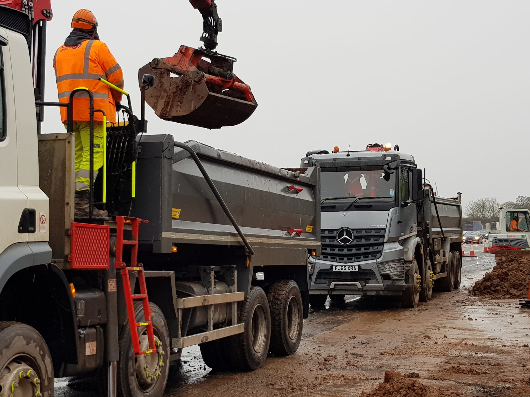 two clearly visible workers working with grabbers